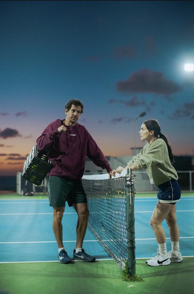 Isa at the net under a dusk sky